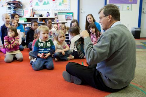 President Thomas J. Haas reads to children at the Children's Enrichment Center. Events will be held throughout April to celebrate Month of the Young Child.