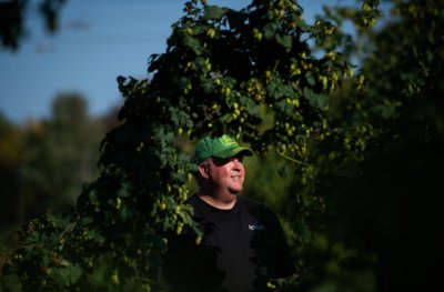 Rob Alway is pictured on his farm, wearing a John Deere hat