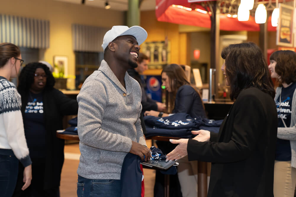 President Mantella talking with student