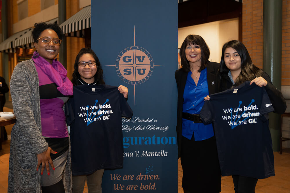 group of students holding t-shirts with President Mantella