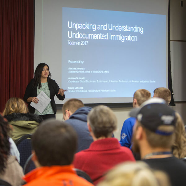 woman giving presentation in front of screen