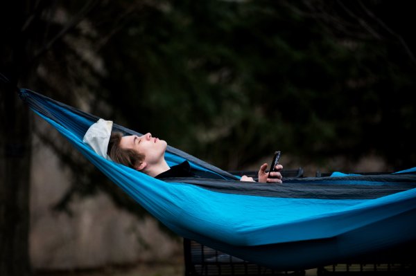 A student rests in a hammock.