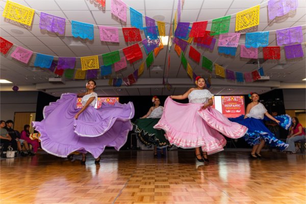 students in colorful Hispanic dresses