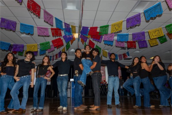 students in fashion show, dressed in jeans and black shirts