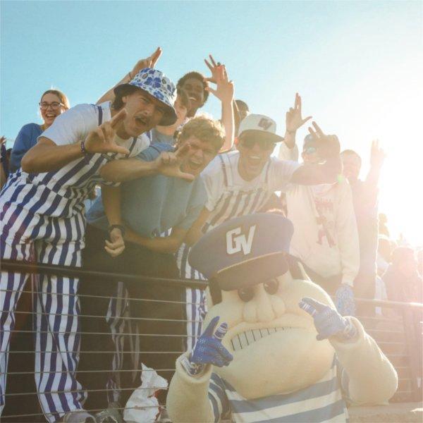 GVSU students pose with Louie the Laker at the Homecoming game.