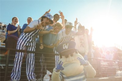GVSU students pose with Louie the Laker at Homecoming.