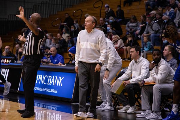 Ric Wesley coaches the men's basketball team from the sidelines during a game.