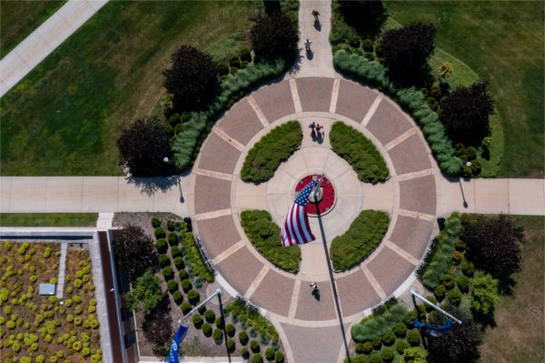Aerial view of pedestrians walking around the flagpole at Lubbers Student Services Center.