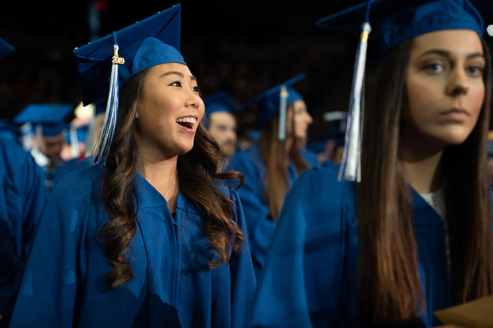 student getting in line for diploma
