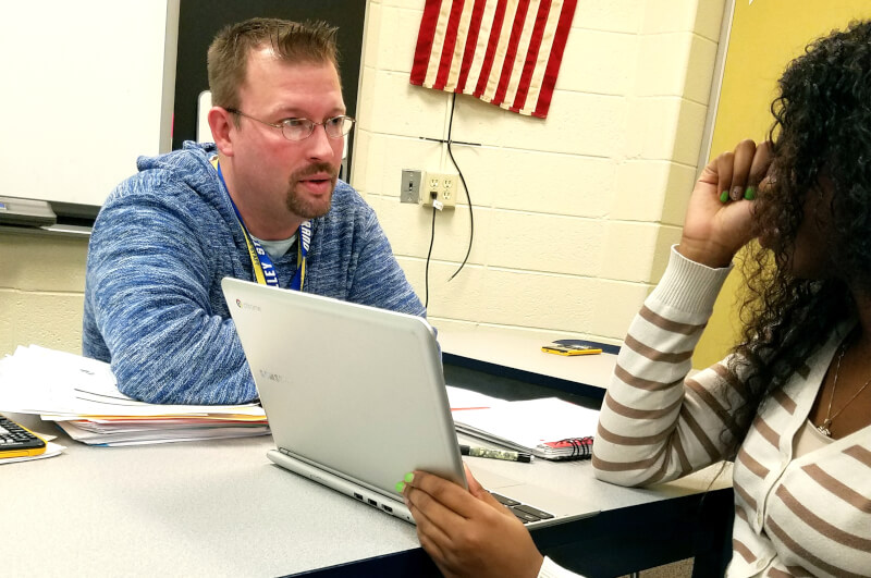 Jeremy Bissett works with a student from Godwin Heights High School.