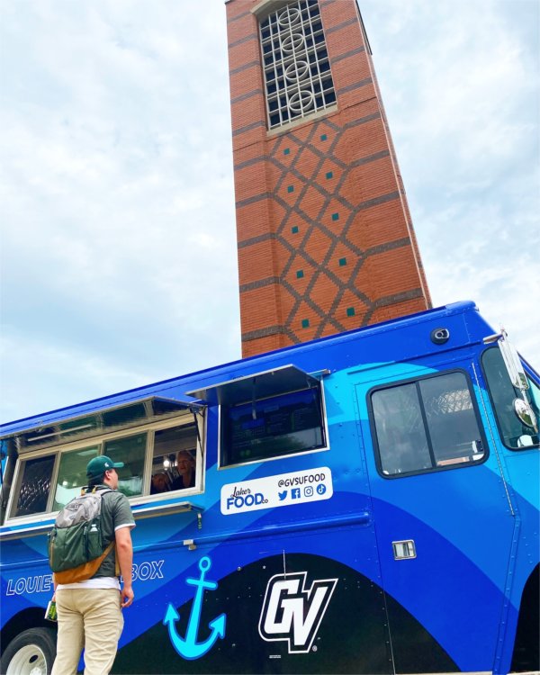 A man orders lunch from Louie's Lunchbox, a new food truck, near the Cook Carillon Tower. 