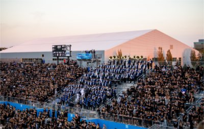 The student section and marching band cheer at a GVSU football game.