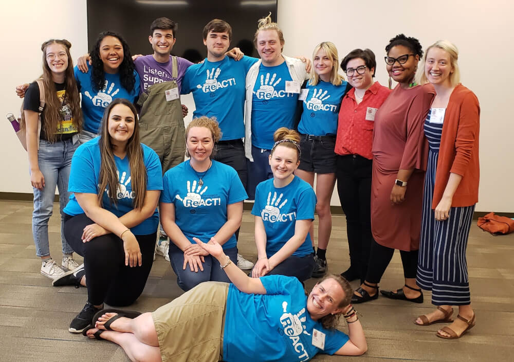 Allison Metz, associate professor of theater, and ReACT! actors pose with members of Voices Against Violence, the University of Texas sexual assault prevention theater troupe that was a model for ReACT!