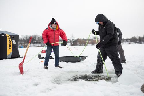 Mark Gleason, assistant professor of tourism and hospitality management, aids in the deployment of an ROV February 20 on Reeds Lake. Photo by Amanda Pitts.
