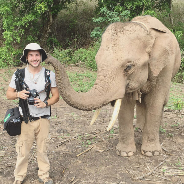 Spencer Rohatynski pictured with an elephant at the Kindred Spirit Elephant Sanctuary in Thailand.