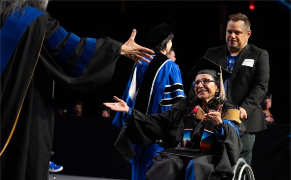 Delia Gale, a graduate of Grand Valley State University's Seidman College of Business, is conferred a Master of Business Administration during the university's morning Commencement on May 2.