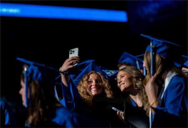 Graduates take a selfie together as they recess out of Saturday morning&#8217;s Commencement ceremony.