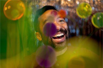 Jeffrey Augustine Songco will be the newest artist to serve as the Padnos Distinguished Artist-in-Residence. He is pictured with his acrylic flowers inside his Allendale home art studio.