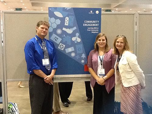 From left, Dan Broresma, Lisa Miller and Melissa Peraino stand by their poster presentation at the AASHE conference.
