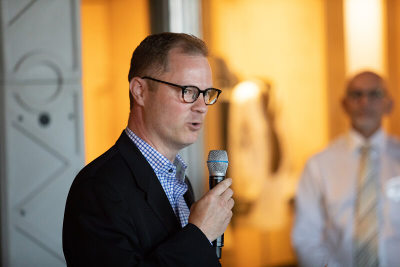 Brian Hauenstein, Ralph Hauenstein's grandson, welcomes guests to the exhibit.