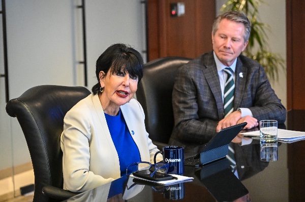 GVSU President Philomena V. Mantella speaks alongside MSU President Kevin Guskiewicz at a conference table.