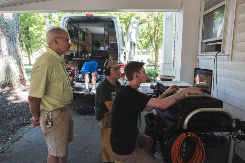 Joe McCargar, affiliate professor of film and video production advises students Nick Cook (back) and Blaine Brown (front) as they set audio levels.