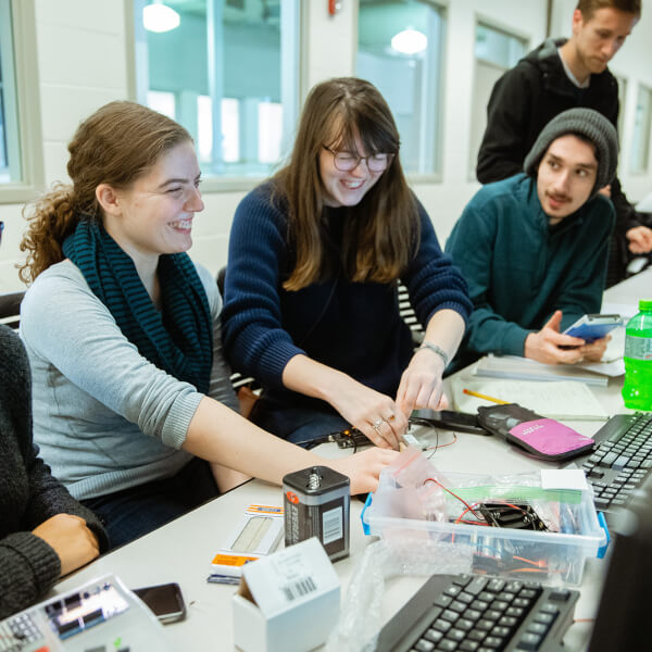 Four students work on an engineering project in the Keller Engineering labs.