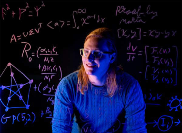 A portrait of a college student among mathmatical figures and numbers. 