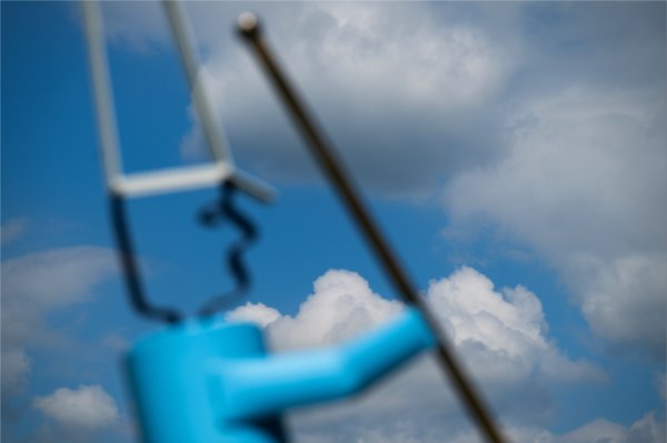  A marching band sculpture is seen against blue sky and puffy white clouds. 