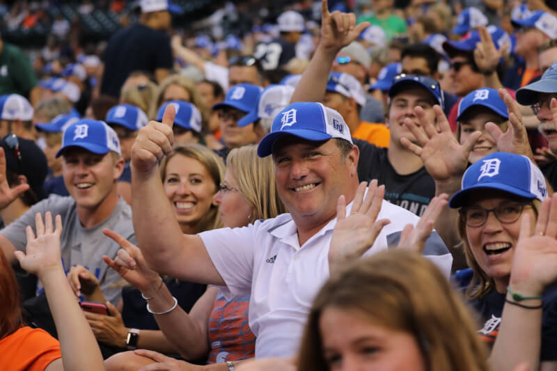  Group of GVSU alumni wearing blue Detroit Tigers hats, smiling