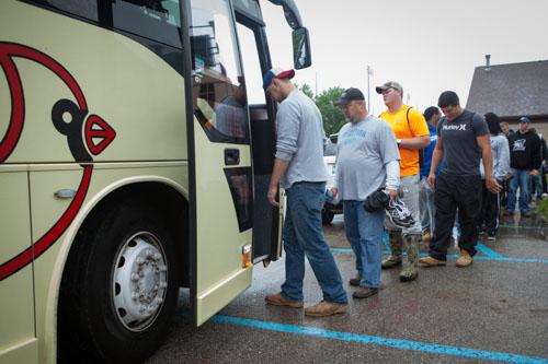 Football players board the bus to assist in the search.