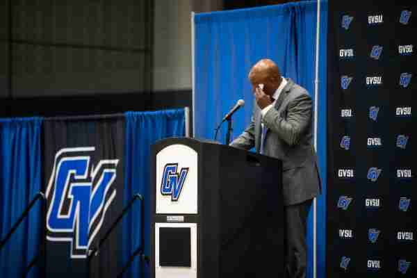 Cornell Mann wipes away tears as he talks about his family during the news conference where he was welcomed as the sixth men's basketball coach in the Grand Valley history.