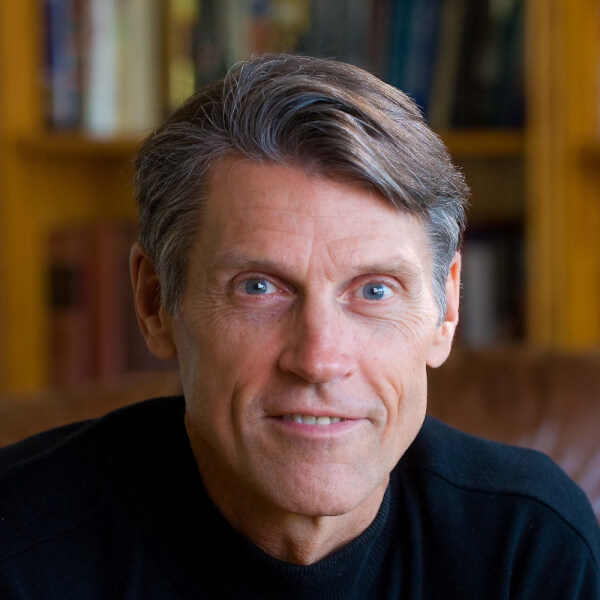 H.W. Brands posed for a portrait at a desk.