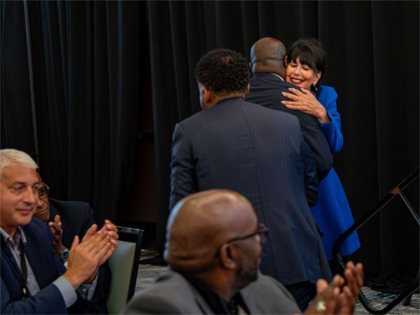 President Philomena V. Mantella hugs Paul Jones, president of Fort Valley State University, after being recognized for an award during the Black Boys and Men National Symposium at the DoubleTree by Hilton in Battle Creek on June 10. 