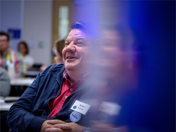 University Communications writer Brian Vernellis smiles during a presentation at GVSU CommCon, a convention for university communicators June 17.