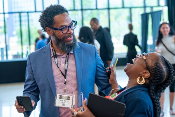 Affiliate professor Tony Warren and Elishae Johnson, of Bronson Healthcare, talk during the Black Boys and Men National Symposium on June 10. 