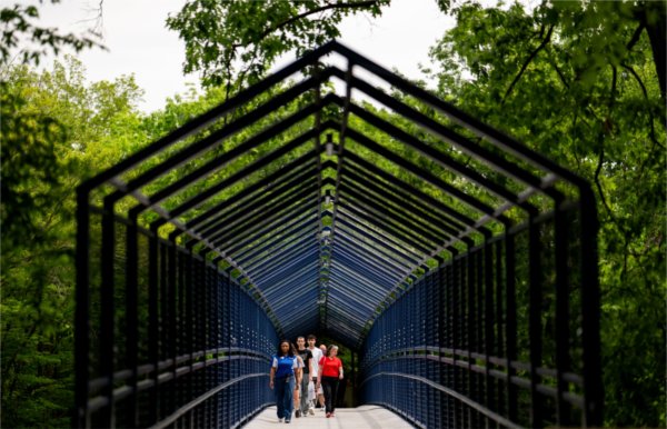 A campus tour crosses the Little Mac Bridge on the Valley Campus June 8.