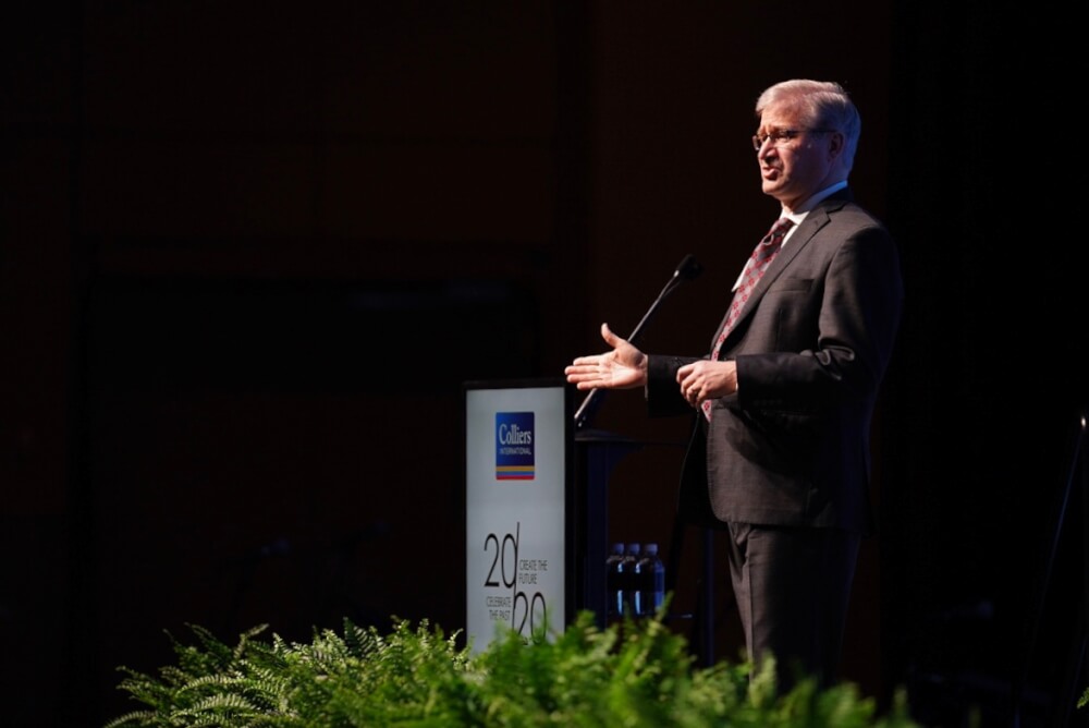 man at podium on stage