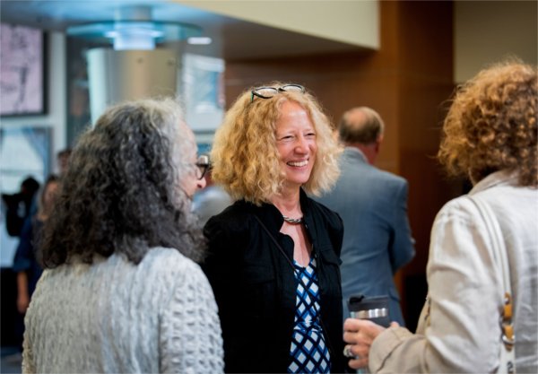 Jennifer Drake in the middle of two other people with backs to camera