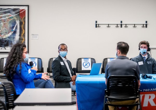 Students at a table during the Guy Gordon radio show.