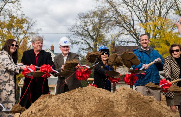Six GVSU leaders hold shovels over a mound of dirt.