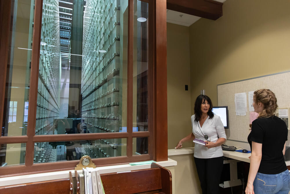 President Mantella listens to information about the Steelcase Library in the DeVos Center.