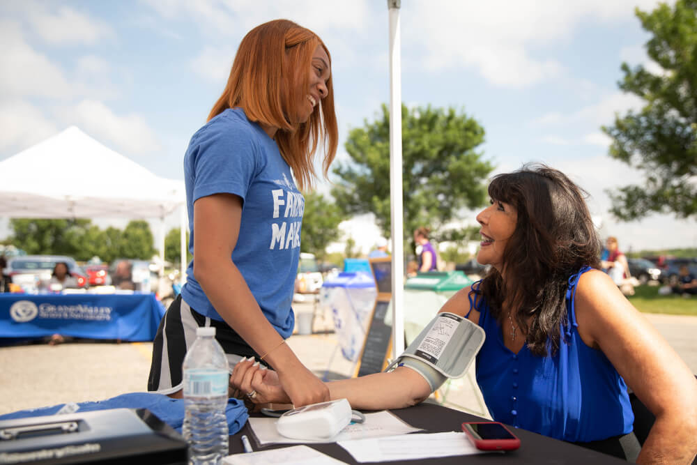 President Mantella is shown a blood pressure screening at the Farmer's Market.