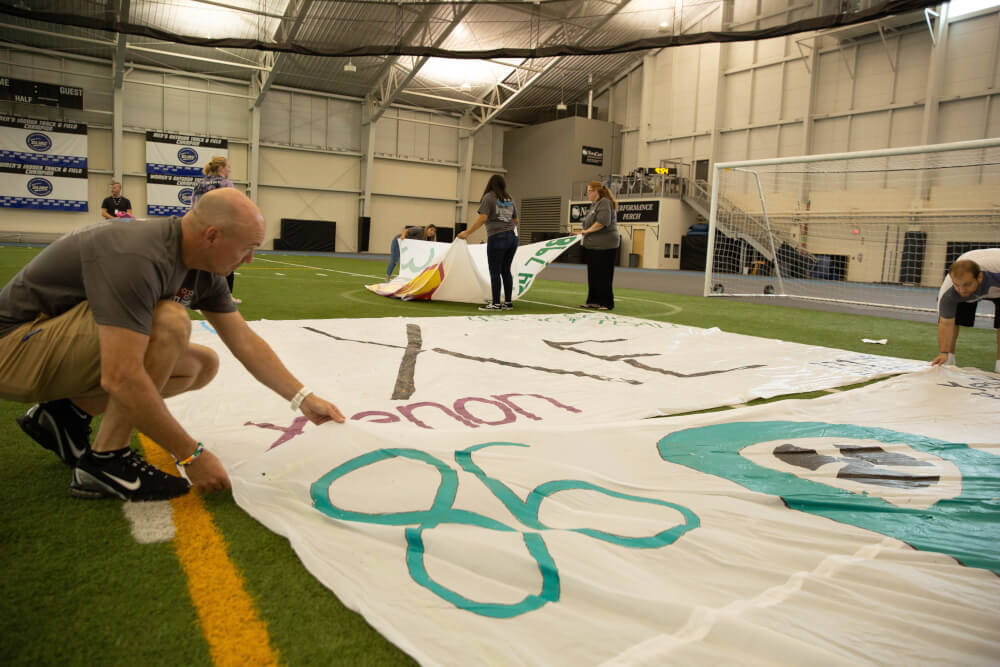Volunteers on July 18 place blocks showing the elements of the periodic table.