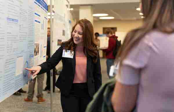 Student discusses her research with a faculty member