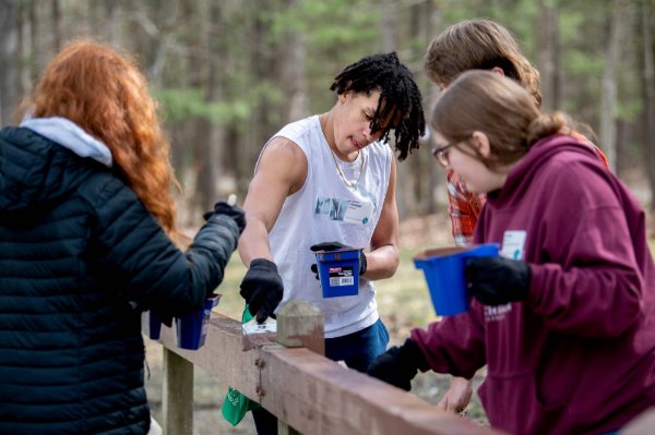 Jedaiah Armour, center, and fellow students from Byron Center Charter School volunteered with Michigan Cares 4 Tourism at the Muskegon Luge Adventure Sports Park and Muskegon State Park on April 19.