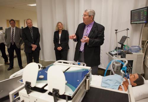 Photos by Elizabeth Lienau<br>Michael W. Wambach, chair of the Allied Health Sciences, discusses the test lung devices from Michigan Instruments with faculty members in the Cook-DeVos Center for Health Sciences. 