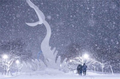 Three students walk through accumulated snow on Valley Campus during a winter storm on Jan. 19.