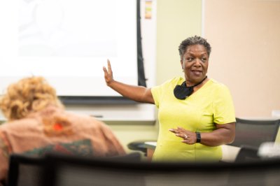 Faye Richardson-Green speaks with students during her honors seminar class