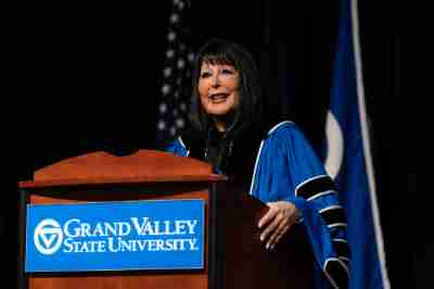 GVSU President Philomena V. Mantella at a podium for the December virtual grad celebration
